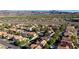 Wide aerial view of a neighborhood showcasing diverse homes against a mountain backdrop at 23 Antero Dr, Henderson, NV 89074