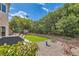 Cozy backyard featuring patio seating, lush plants, and a meticulously maintained lawn for outdoor enjoyment at 23 Antero Dr, Henderson, NV 89074