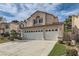 Charming two-story home with a three-car garage and a well-maintained front yard, creating curb appeal at 23 Antero Dr, Henderson, NV 89074