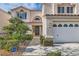 Inviting front exterior showcases manicured landscaping, a two-car garage, and a welcoming entrance at 23 Antero Dr, Henderson, NV 89074