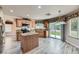 Bright kitchen featuring wood-look tile flooring, wood cabinets, island, stainless appliances and natural light at 23 Antero Dr, Henderson, NV 89074