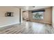 Bright living room featuring wood-look tile flooring, natural light, and neutral paint with TV mount at 23 Antero Dr, Henderson, NV 89074