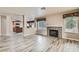 Spacious living room featuring fireplace, wood-look tile flooring, and open concept layout at 23 Antero Dr, Henderson, NV 89074