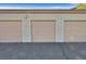 Beige detached garages, three doors and black asphalt driveway at 2305 W Horizon Ridge Pkwy # 3324, Henderson, NV 89052