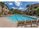 Community pool with lounge chairs and lush landscaping at 2305 W Horizon Ridge Pkwy # 3324, Henderson, NV 89052