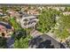 An aerial view of a luxury home with a private driveway and meticulous landscaping with mature palm trees at 2309 Prometheus Ct, Henderson, NV 89074