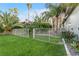 Grassy backyard featuring a secure white fence, mature trees, and colorful landscaping, ensuring privacy at 2309 Prometheus Ct, Henderson, NV 89074