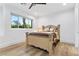 Comfortable bedroom featuring wood floors, a ceiling fan, and view from the window at 2309 Prometheus Ct, Henderson, NV 89074