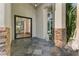 Grand entryway with stone accents, tiled floor, and black frame glass door at 2309 Prometheus Ct, Henderson, NV 89074