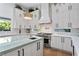 Bright kitchen with modern appliances, white cabinets, large island with quartz countertop, and hardwood floors at 2309 Prometheus Ct, Henderson, NV 89074