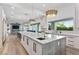 Large open kitchen with marble island and modern pendant lighting at 2309 Prometheus Ct, Henderson, NV 89074