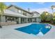 Gorgeous backyard featuring a large pool, covered patio with outdoor kitchen, and beautifully designed landscaping at 2309 Prometheus Ct, Henderson, NV 89074