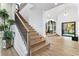 Open staircase with wooden steps and iron railings leading to the second floor and hardwood floors at 2309 Prometheus Ct, Henderson, NV 89074