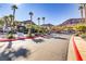 Inviting community entrance with lush landscaping, palm trees, and well-maintained street at 231 W Horizon Ridge Pkwy # 2413, Henderson, NV 89012