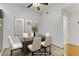 Virtually staged dining area with hardwood floors, modern ceiling fan, framed art and an open doorway to the bathroom at 231 W Horizon Ridge Pkwy # 2413, Henderson, NV 89012