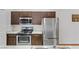 Close-up of a modern kitchen featuring stainless steel appliances, sleek countertops, and dark wood cabinets at 231 W Horizon Ridge Pkwy # 2413, Henderson, NV 89012