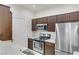 Well-equipped kitchen featuring stainless steel appliances and elegant dark wood cabinetry at 231 W Horizon Ridge Pkwy # 2413, Henderson, NV 89012