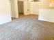 View of the open-concept living room shows the neutral carpet and a partial view of the kitchen at 231 W Horizon Ridge Pkwy # 527, Henderson, NV 89012
