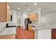 Modern kitchen featuring granite counters, stainless steel appliances, breakfast bar, and wood floors at 2520 Eclipsing Stars Dr, Henderson, NV 89044