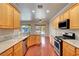 Updated kitchen featuring stainless steel appliances, granite countertops, and wood floors looking out at the pool at 2520 Eclipsing Stars Dr, Henderson, NV 89044