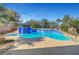 Refreshing pool with blue tile accents and lush landscaping creates a serene backyard oasis at 2520 Eclipsing Stars Dr, Henderson, NV 89044