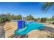 Sparkling blue pool with tile accents and lush plants for a serene backyard retreat at 2520 Eclipsing Stars Dr, Henderson, NV 89044