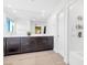 Modern bathroom with double sinks, large mirror, and a shower with sleek white tile at 2536 Catallo St, Henderson, NV 89044