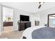 Comfortable bedroom featuring a ceiling fan, television and ensuite bathroom at 2536 Catallo St, Henderson, NV 89044