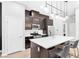 Modern kitchen with stainless steel appliances, quartz countertops, and a large island with seating at 2536 Catallo St, Henderson, NV 89044