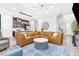 Open-concept living area showcasing a large leather sofa, modern decor, and a seamless kitchen connection at 2536 Catallo St, Henderson, NV 89044