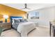Serene primary bedroom featuring a stylish accent wall, ceiling fan, and ample natural light at 2536 Catallo St, Henderson, NV 89044