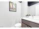 Powder room with updated fixtures, a unique print, and a decorative plant at 2536 Catallo St, Henderson, NV 89044