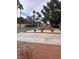 Wide driveway and street view lined with lush, mature trees and desert landscaping at 2711 Seabridge Dr, Las Vegas, NV 89121