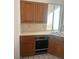 Kitchen area with tile countertops, sink, dishwasher and wooden cabinets at 2711 Seabridge Dr, Las Vegas, NV 89121