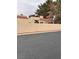 Residential street view of a tan house with red tile roof behind a wall at 2711 Seabridge Dr, Las Vegas, NV 89121