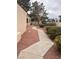 Walkway with desert landscaping, shrubs and trees leading to a well-maintained property at 2711 Seabridge Dr, Las Vegas, NV 89121