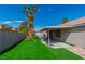 Spacious backyard featuring artificial turf, a covered patio, and a playset at 2913 Bradford Hill Ave, North Las Vegas, NV 89031