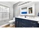 Bathroom featuring a double sink vanity, a large mirror, and a window for natural light at 2913 Bradford Hill Ave, North Las Vegas, NV 89031