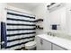 Bathroom featuring a shower with a striped curtain, open shelving, and modern fixtures at 2913 Bradford Hill Ave, North Las Vegas, NV 89031