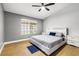 Bedroom featuring hardwood floors, a window overlooking the backyard, and neutral paint at 2913 Bradford Hill Ave, North Las Vegas, NV 89031