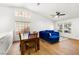 Cozy living room combines dining and living areas featuring lots of windows and wood flooring at 2913 Bradford Hill Ave, North Las Vegas, NV 89031