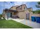 Cozy backyard featuring a hot tub, artificial grass, and a pergola for shade at 3066 Casarano Ct, Henderson, NV 89044