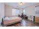 Bedroom featuring wood floors, a large window, and modern window coverings at 3066 Casarano Ct, Henderson, NV 89044