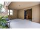 View of covered patio featuring a ceiling fan, stone pillars, and adjacent backyard access at 3066 Casarano Ct, Henderson, NV 89044