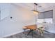 Eat-in dining area off the kitchen featuring a modern light fixture and wood table at 3066 Casarano Ct, Henderson, NV 89044