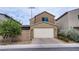 Charming two-story home features a neutral color palette, a two-car garage, and landscaped front yard at 3066 Casarano Ct, Henderson, NV 89044