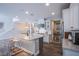 Bright, open kitchen featuring white cabinetry, an oversized island, and stainless steel appliances at 3066 Casarano Ct, Henderson, NV 89044