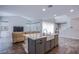 Modern open-concept kitchen with a large kitchen island including a farmhouse sink at 3066 Casarano Ct, Henderson, NV 89044