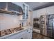 Beautiful kitchen with stainless steel appliances and white cabinets with marble countertops at 3066 Casarano Ct, Henderson, NV 89044