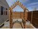 Backyard featuring a garden with raised beds, a wooden archway and a wood fence at 325 Ron Ave, Logandale, NV 89021